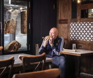 Tom Kerridge enjoying a hotdog at The Butcher's Tap & Grill